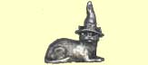 Witch's cat in a witches hat lying down, cast in metal.